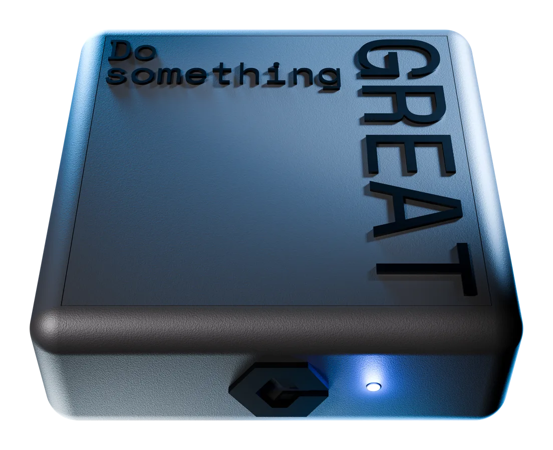 FocusField in three quarter view, its matte near black body carrying "Do something GREAT" debossed across the top face, with the hexagon mark and a lit blue status light on the front face.